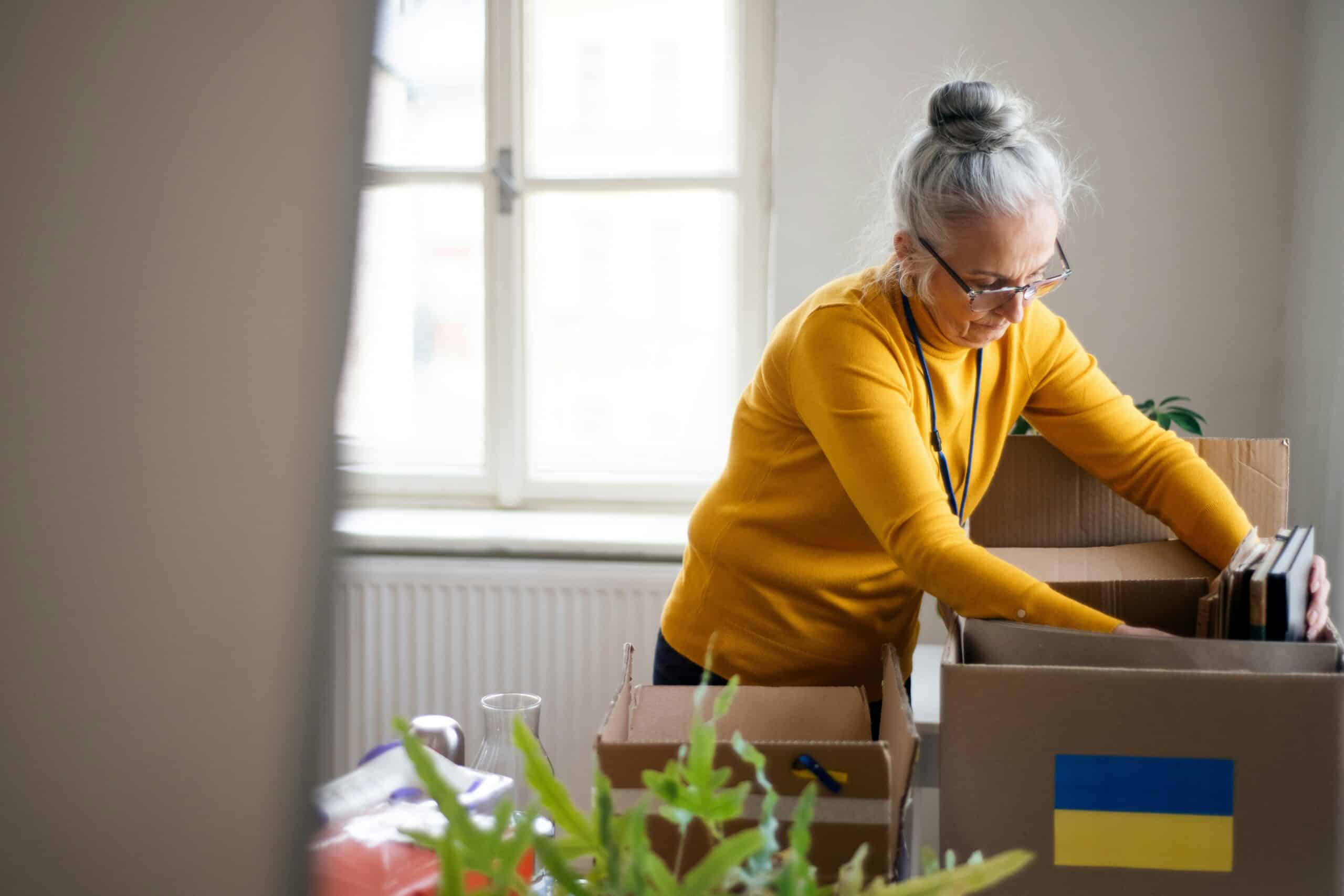 Labeled moving boxes organized for a senior’s move into assisted living."