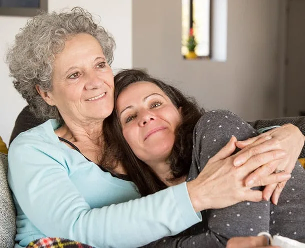 Adult daughter embracing her mother while considering assisted living in Denver, Colorado